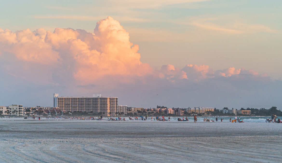 Clouds illuminated by the sun durring sunset above the many condo along Siesta Key beach