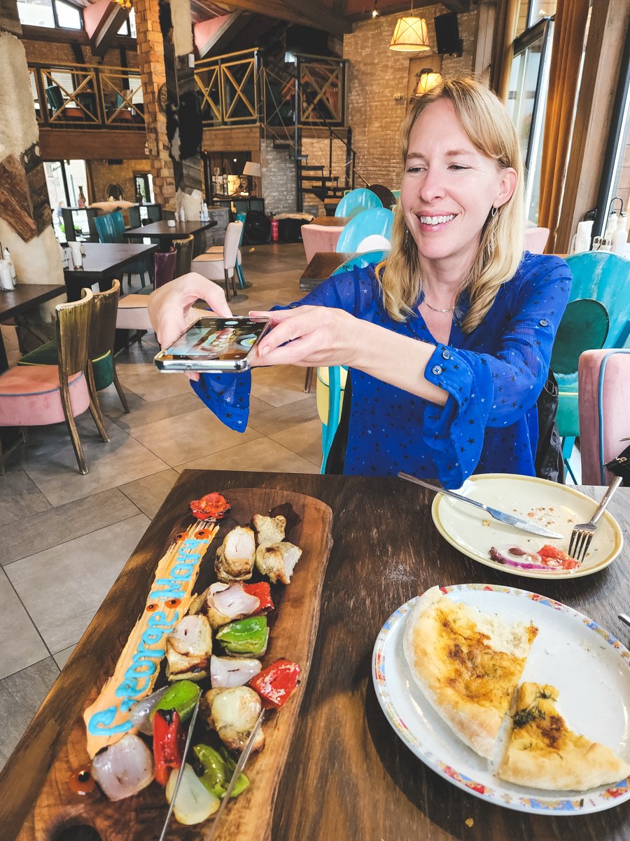 Travel blogger Michelle Hartz seen photographing a meal at George and mary's restaurant in Bansko Bulgaria