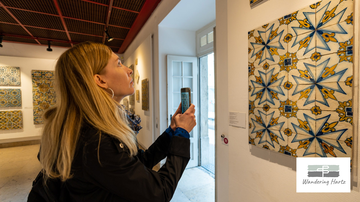 woman taking photo of lovely Portuguese tile in the National Tile Museum Lisbon Portugal
