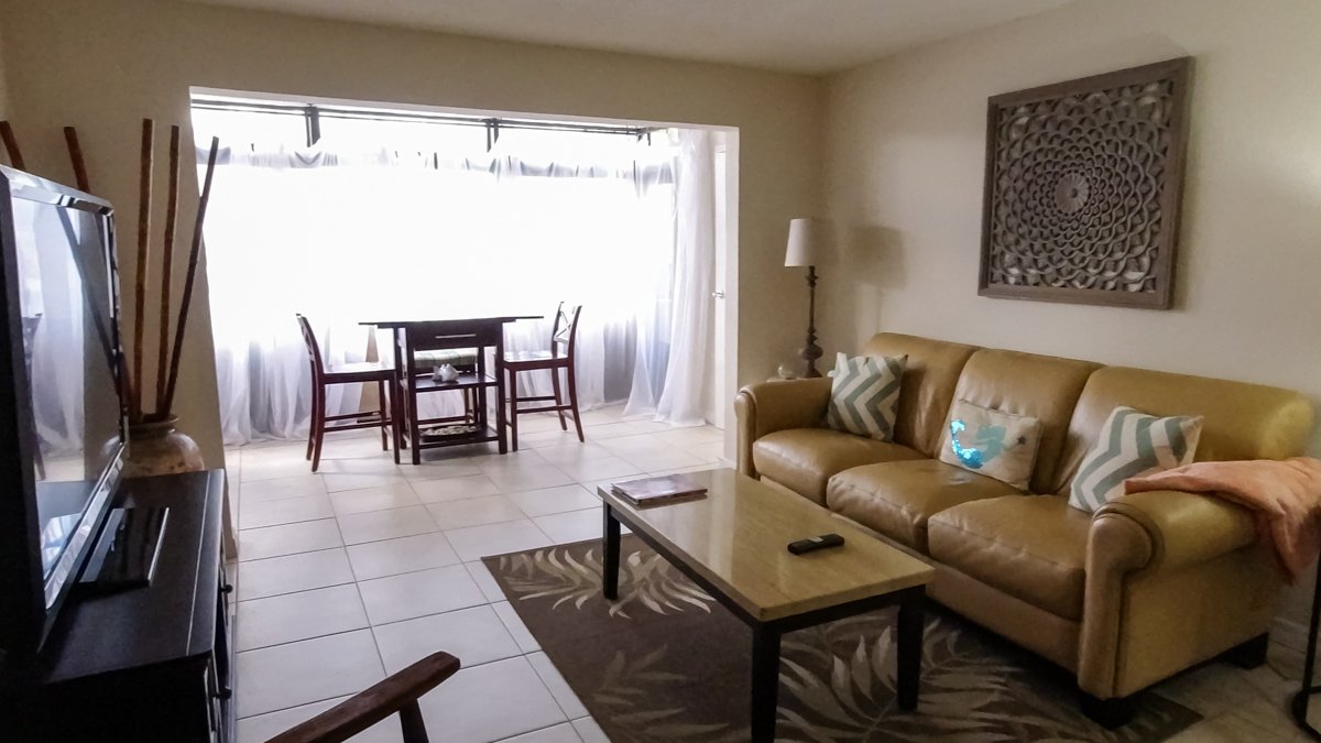 interior living room of condo with sunroom © Joel Hartz