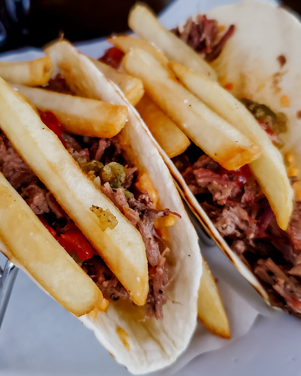 Close up of pork Tacos with french fries on top from Lucky's in Rincon Puerto Rico