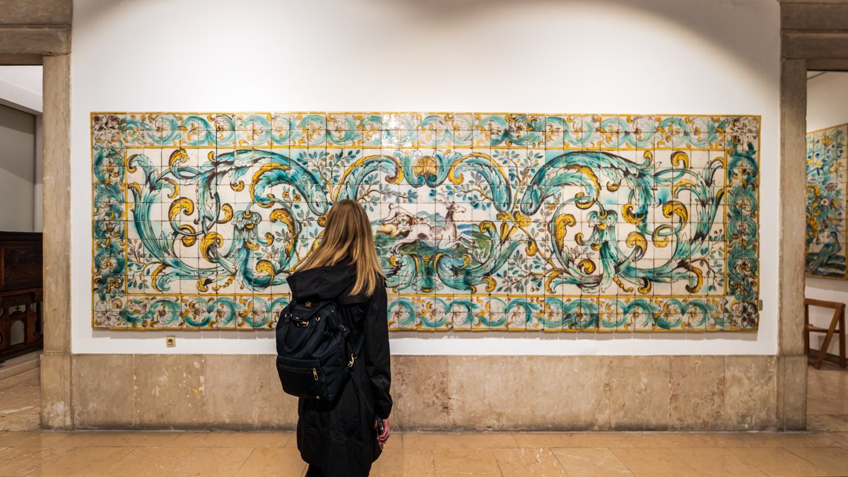 Woman admiring large Portuguese tile arrangement at the National Tile Museum Lisbon © Joel Hartz