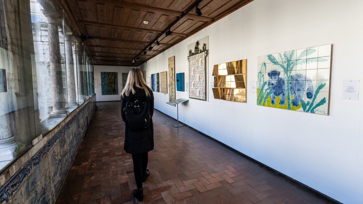 woman viewing the modern tile installations at the National Tile Museum Lisbon Portugal