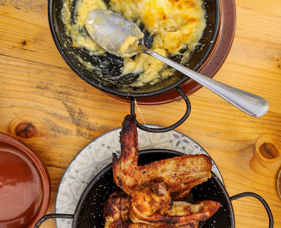 overhead shot of chicken wings and baked cod in portugal