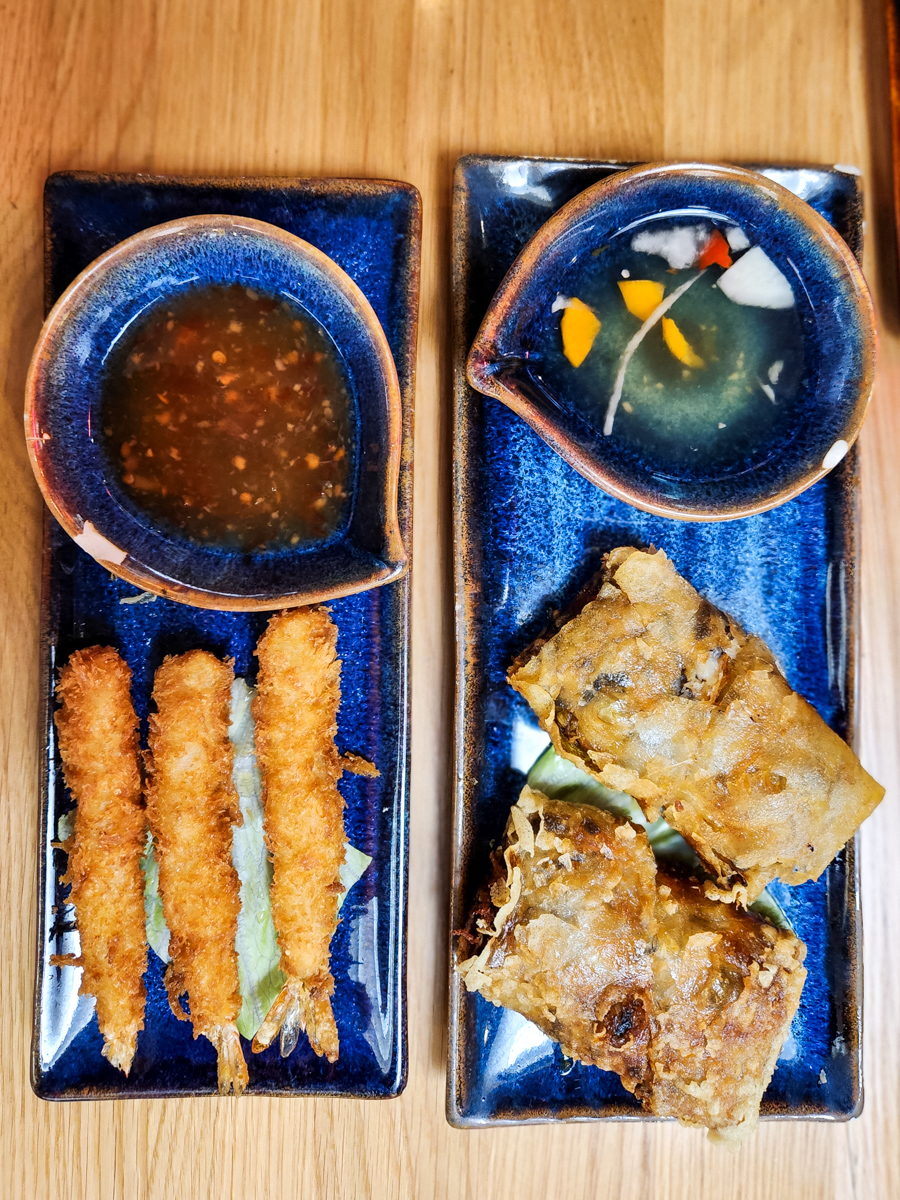 overhead view of two Vietnamese dishes on blue plates