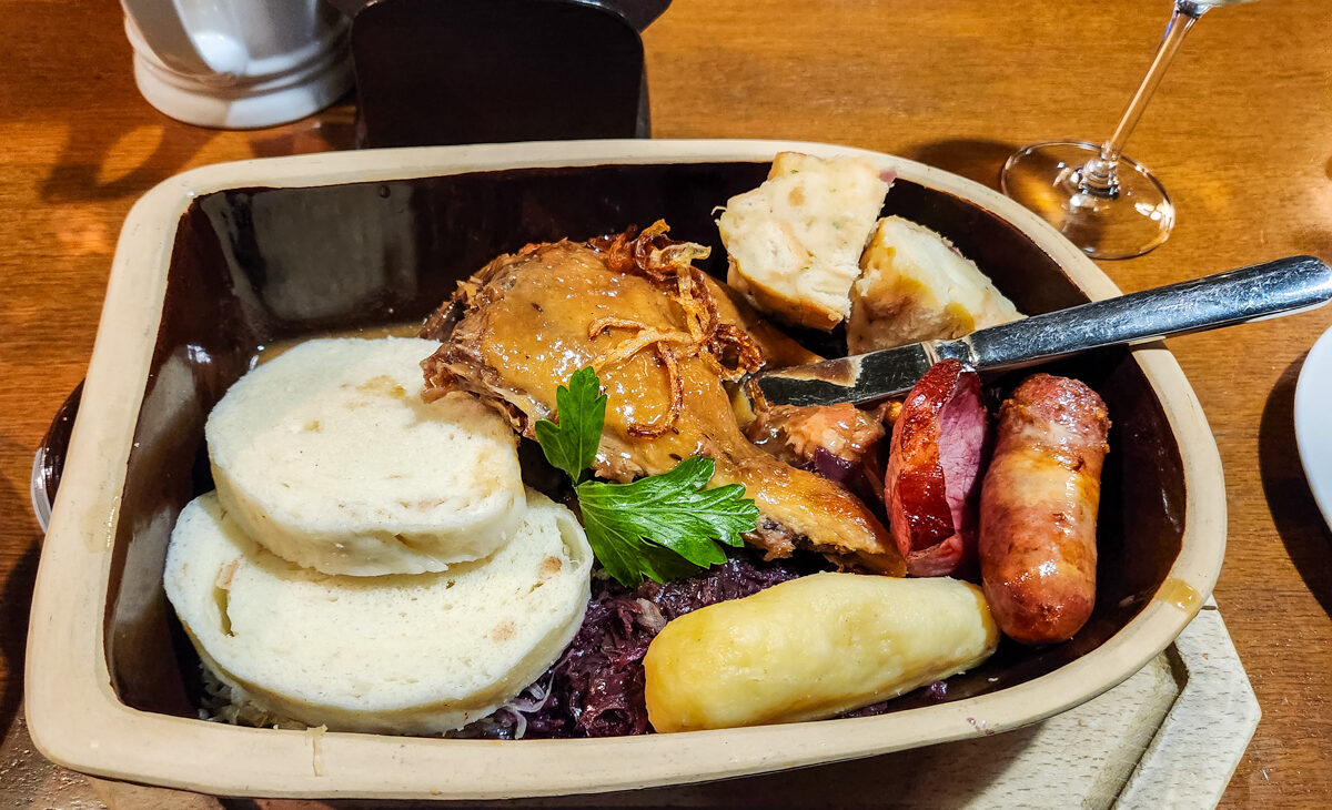 A common dish of Czech food. suck , potate , sausage and red cabbage sauerkraut