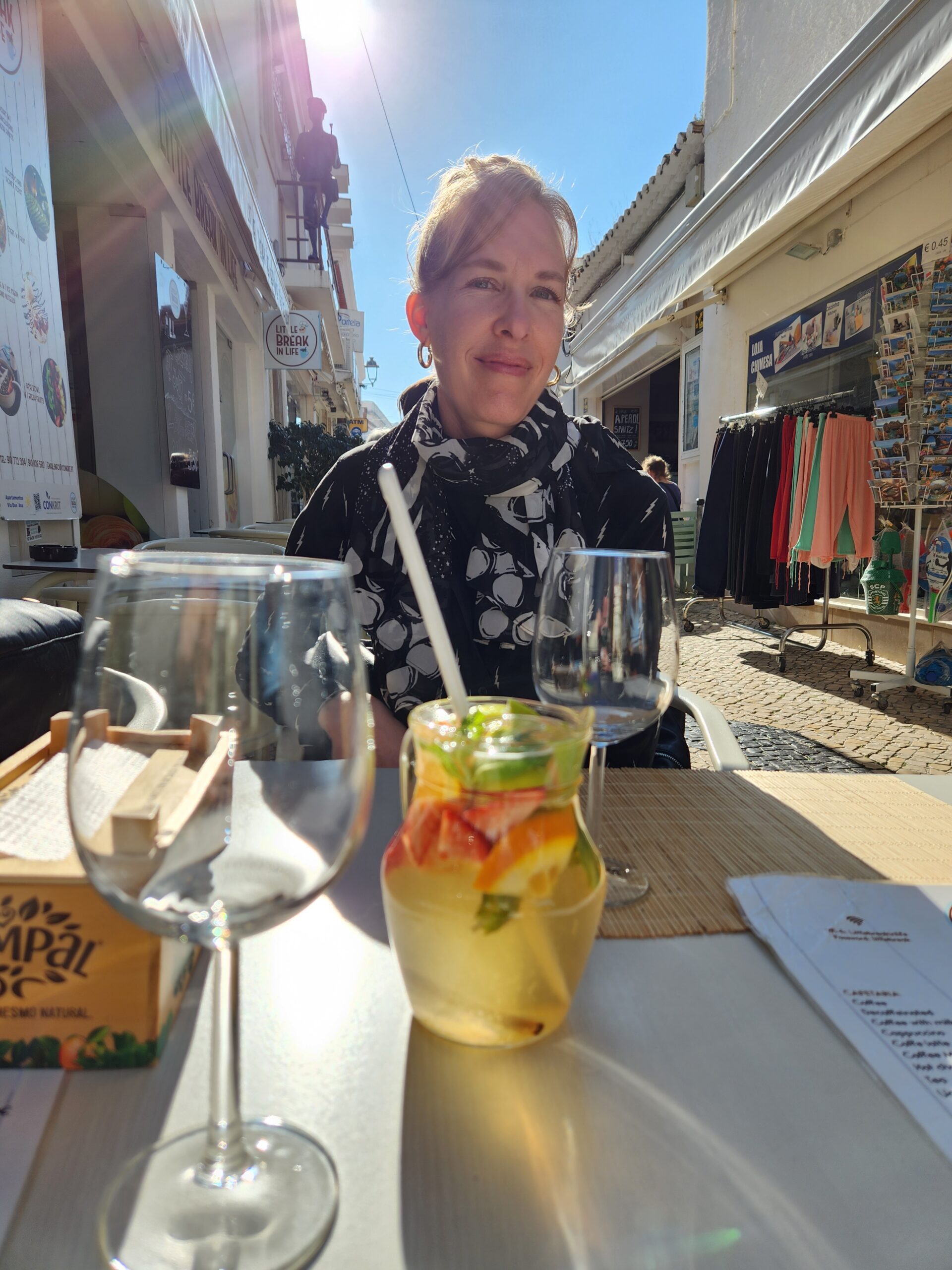 Michelle sitting at outdoor table in Portugal