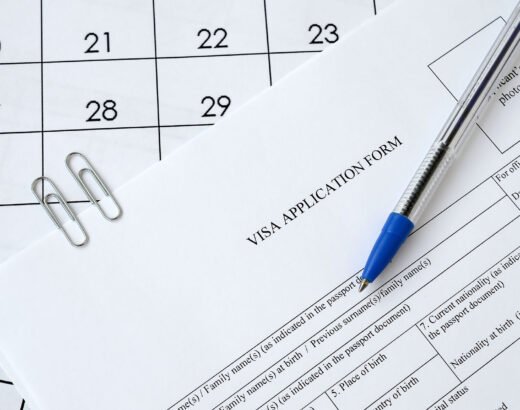 Typical Visa application form and blue pen on paper calendar page