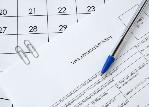 Typical Visa application form and blue pen on paper calendar page