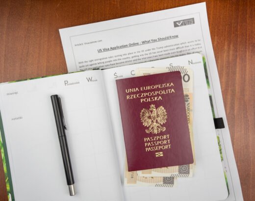 Top view of the Polish red passport with banknotes and documents on the wooden surface