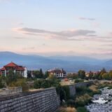 river bed with little water in summer with mountains in background at sunset