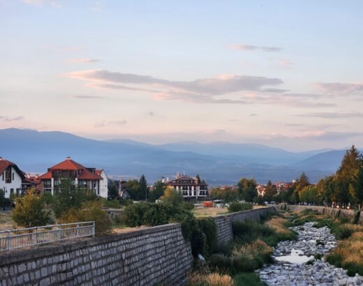 river bed with little water in summer with mountains in background at sunset