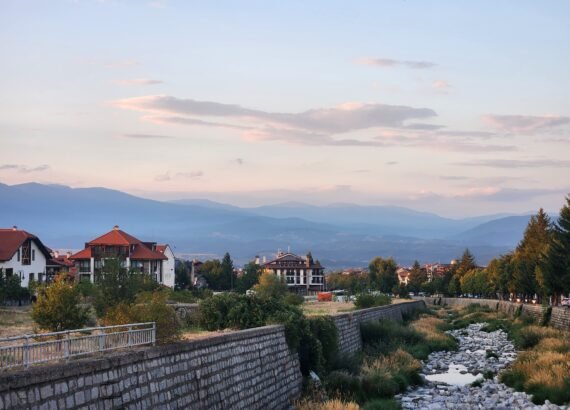river bed with little water in summer with mountains in background at sunset